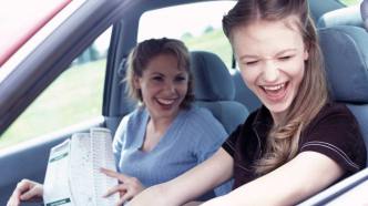 Teen girl driving with mom